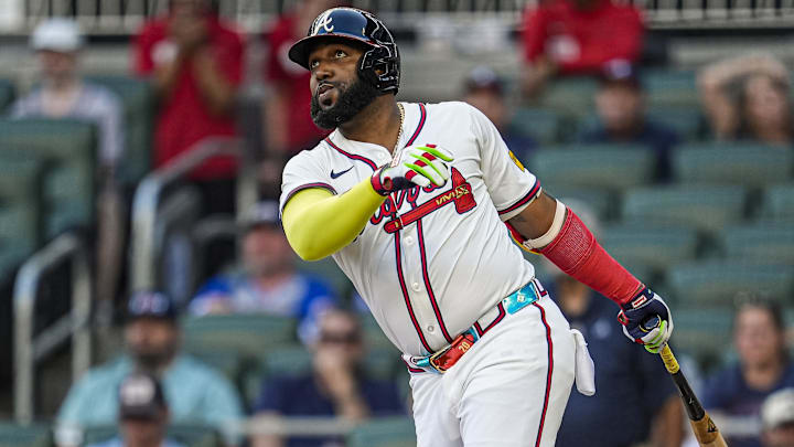 Aug 7, 2025; Cumberland, Georgia, USA; Atlanta Braves designated hitter Marcell Ozuna (20) hits a home run against the Miami Marlins during the second inning at Truist Park. Mandatory Credit: Dale Zanine-Imagn Images