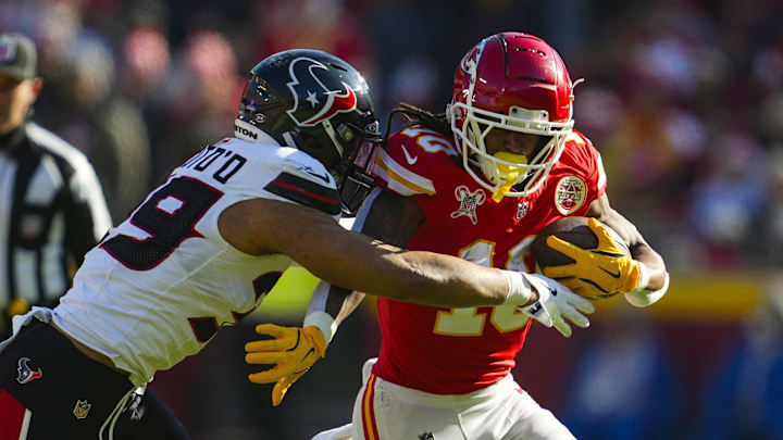 Dec 21, 2024; Kansas City, Missouri, USA; Kansas City Chiefs running back Isiah Pacheco (10) runs the ball against Houston Texans linebacker Henry To'oTo'o (39) during the first half at GEHA Field at Arrowhead Stadium. Mandatory Credit: Jay Biggerstaff-Imagn Images