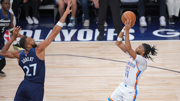 May 24, 2025; Minneapolis, Minnesota, USA; Oklahoma City Thunder guard Isaiah Joe (11) shoots the ball over Minnesota Timberwolves center Rudy Gobert (27) during the second half in game three of the western conference finals for the 2025 NBA Playoffs at Target Center. Mandatory Credit: Brad Rempel-Imagn Images