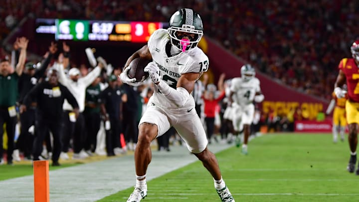 Sep 20, 2025; Los Angeles, California, USA; Michigan State Spartans wide receiver Chrishon McCray (13) scores a touchdown against the against the Southern California Trojans during the first half at the Los Angeles Memorial Coliseum. Mandatory Credit: Gary A. Vasquez-Imagn Images