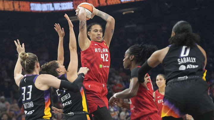 Atlanta Dream center Brittney Griner (42) passes the ball while defended by Phoenix Mercury forward Kathryn Westbeld (24) and guard Sami Whitcomb (33) during the first quarter at PHX Arena Jul 23, 2025.
