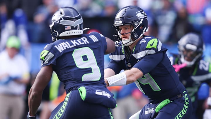 Nov 9, 2025; Seattle, Washington, USA; Seattle Seahawks quarterback Sam Darnold (14) hands the ball off to Seattle Seahawks running back Kenneth Walker III (9) during the first quarter at Lumen Field. Mandatory Credit: Kevin Ng-Imagn Images