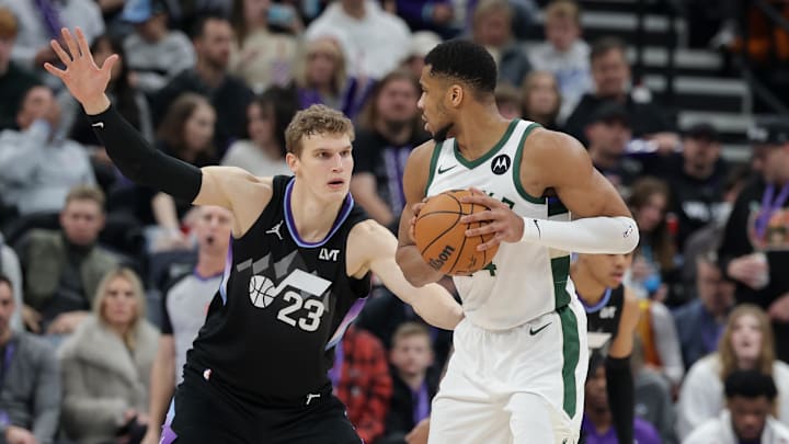Jan 27, 2025; Salt Lake City, Utah, USA;  Milwaukee Bucks forward Giannis Antetokounmpo (34) keeps the ball away from Utah Jazz forward Lauri Markkanen (23) during the second half at Delta Center. Mandatory Credit: Chris Nicoll-Imagn Images