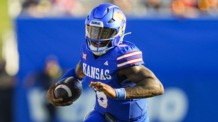 Aug 23, 2025; Lawrence, Kansas, USA; Kansas Jayhawks quarterback Jalon Daniels (6) runs the ball during the first half against the Fresno State Bulldogs at David Booth Kansas Memorial Stadium. Mandatory Credit: Jay Biggerstaff-Imagn Images Aug 23, 2025; Lawrence, Kansas, USA; Kansas Jayhawks quarterback Jalon Daniels (6) runs the ball during the first half against the Fresno State Bulldogs at David Booth Kansas Memorial Stadium. Mandatory Credit: Jay Biggerstaff-Imagn Images