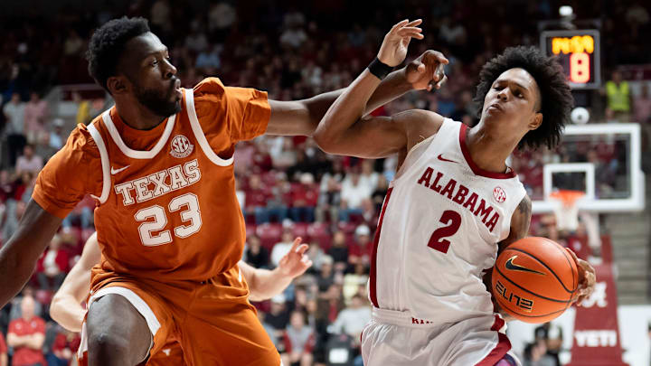 Jan 10, 2026; Tuscaloosa, AL, USA; Texas forward Lassina Traore (23) defends a drive by Alabama guard Aden Holloway (2) at Coleman Coliseum. Mandatory Credit: Gary Cosby Jr.-Tuscaloosa News