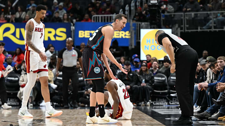 Jan 1, 2026; Detroit, Michigan, USA; Detroit Pistons forward Duncan Robinson (55) argues with referee Curtis Blair (74) after being called for a foul against the Miami Heat in the first quarter at Little Caesars Arena. Mandatory Credit: Lon Horwedel-Imagn Images