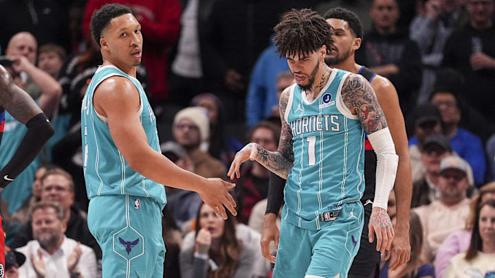 Feb 9, 2026; Charlotte, North Carolina, USA; Charlotte Hornets guard LaMelo Ball (1) and forward Grant Williams (2) after a thee point play against the Detroit Pistons during the second half at Spectrum Center. Mandatory Credit: Jim Dedmon-Imagn Images