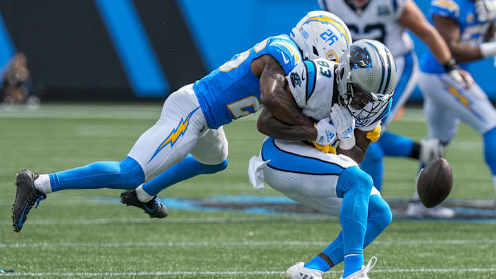 Sep 15, 2024; Charlotte, North Carolina, USA; Los Angeles Chargers cornerback Asante Samuel Jr. (26) tackles Carolina Panthers defensive end LaBryan Ray (93) during the second half at Bank of America Stadium. Mandatory Credit: Jim Dedmon-Imagn Images Sep 15, 2024; Charlotte, North Carolina, USA; Los Angeles Chargers cornerback Asante Samuel Jr. (26) tackles Carolina Panthers defensive end LaBryan Ray (93) during the second half at Bank of America Stadium. Mandatory Credit: Jim Dedmon-Imagn Images