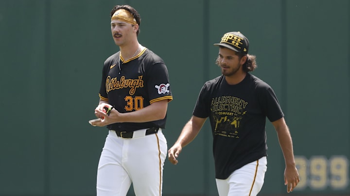 May 26, 2024; Pittsburgh, Pennsylvania, USA;  Pittsburgh Pirates pitchers Paul Skenes (left) and Jared Jones (right) walk in the outfield before the game against the Atlanta Braves at PNC Park.