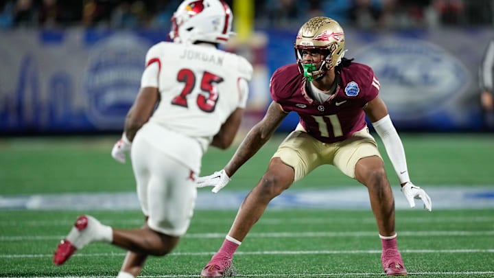Dec 2, 2023; Charlotte, NC, USA; Florida State Seminoles defensive lineman Patrick Payton (11) defends Louisville Cardinals running back Jawhar Jordan (25) during the third quarter at Bank of America Stadium. Mandatory Credit: Jim Dedmon-Imagn Images Dec 2, 2023; Charlotte, NC, USA; Florida State Seminoles defensive lineman Patrick Payton (11) defends Louisville Cardinals running back Jawhar Jordan (25) during the third quarter at Bank of America Stadium. Mandatory Credit: Jim Dedmon-Imagn Images