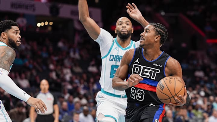 Nov 6, 2024; Charlotte, North Carolina, USA; Detroit Pistons guard Jaden Ivey (23) goes to the basket against Charlotte Hornets forward Taj Gibson (67) during the first quarter at Spectrum Center. Mandatory Credit: Jim Dedmon-Imagn Images