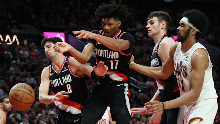 Mar 25, 2025; Portland, Oregon, USA; Portland Trail Blazers forward Deni Avdija (8), guard Shaedon Sharpe (17), center Donovan Clingan (23) and Cleveland Cavaliers center Jarrett Allen (31) fight for a loose ball in the first half at Moda Center. Mandatory Credit: Jaime Valdez-Imagn Images Mar 25, 2025; Portland, Oregon, USA; Portland Trail Blazers forward Deni Avdija (8), guard Shaedon Sharpe (17), center Donovan Clingan (23) and Cleveland Cavaliers center Jarrett Allen (31) fight for a loose ball in the first half at Moda Center. Mandatory Credit: Jaime Valdez-Imagn Images