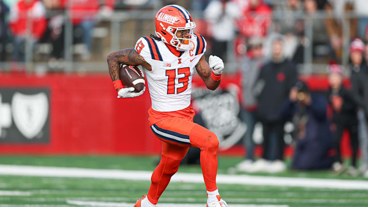 Nov 23, 2024; Piscataway, New Jersey, USA; Illinois Fighting Illini wide receiver Pat Bryant (13) gains yards after catch during the second half against the Rutgers Scarlet Knights at SHI Stadium. Mandatory Credit: Vincent Carchietta-Imagn Images