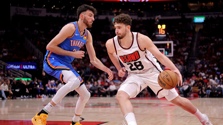 Apr 4, 2025; Houston, Texas, USA; Houston Rockets center Alperen Sengun (28) handles the ball against Oklahoma City Thunder forward Chet Holmgren (7) during the first quarter at Toyota Center. Mandatory Credit: Erik Williams-Imagn Images