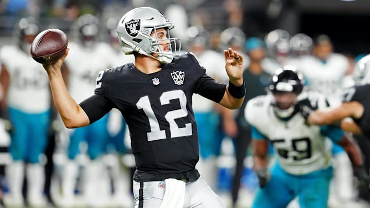 Dec 22, 2024; Paradise, Nevada, USA; Las Vegas Raiders quarterback Aidan O'Connell (12) looks to pass against the Jacksonville Jaguars during the third quarter at Allegiant Stadium. Mandatory Credit: Stephen R. Sylvanie-Imagn Images
