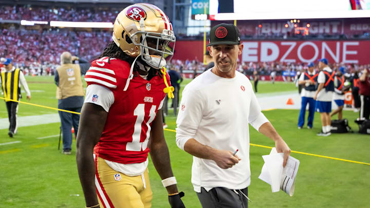 Dec 17, 2023; Glendale, Arizona, USA; San Francisco 49ers head coach Kyle Shanahan talks to wide receiver Brandon Aiyuk (11) against the Arizona Cardinals at State Farm Stadium. Mandatory Credit: Mark J. Rebilas-USA TODAY Sports
