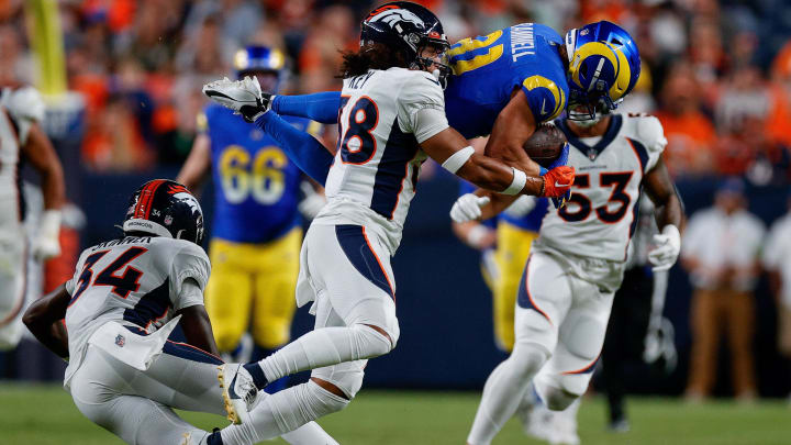 Aug 26, 2023; Denver, Colorado, USA; Los Angeles Rams wide receiver Austin Trammell (81) is upended by Denver Broncos safety JL Skinner (34) as safety Devon Key (38) defends in the third quarter at Empower Field at Mile High. Mandatory Credit: Isaiah J. Downing-USA TODAY Sports