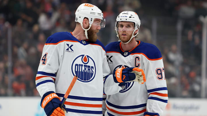 Dec 29, 2024; Anaheim, California, USA;  Edmonton Oilers center Connor McDavid (97) talks to defenseman Mattias Ekholm (14) during the first period against the Anaheim Ducks at Honda Center. Mandatory Credit: Kiyoshi Mio-Imagn Images