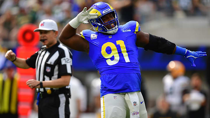Oct 6, 2024; Inglewood, California, USA; Los Angeles Rams defensive tackle Kobie Turner (91) reacts after sacking Green Bay Packers quarterback Jordan Love (10) during the first half at SoFi Stadium. Mandatory Credit: Gary A. Vasquez-Imagn Images