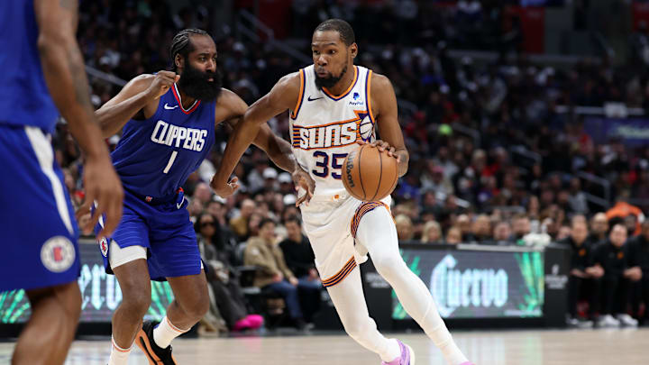 Jan 8, 2024; Los Angeles, California, USA;  Phoenix Suns forward Kevin Durant (35) dribbles the ball against Los Angeles Clippers guard James Harden (1) during the fourth quarter at Crypto.com Arena. Mandatory Credit: Kiyoshi Mio-Imagn Images