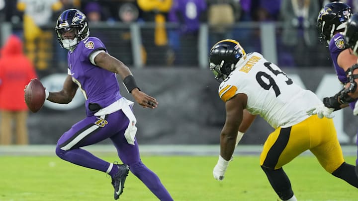 Dec 21, 2024; Baltimore, Maryland, USA; Baltimore Ravens quarterback Lamar Jackson (8) scrambles during the first quarter pressured by Pittsburgh Steelers tackle Keeanu Benton (95) at M&T Bank Stadium. Mandatory Credit: Mitch Stringer-Imagn Images
