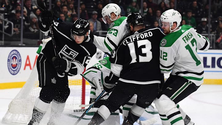Jan 8, 2020; Los Angeles, California, USA; Los Angeles Kings right wing Dustin Brown (23) and left wing Kyle Clifford (13) battle for the puck with Dallas Stars defenseman Esa Lindell (23) and center Radek Faksa (12)   in the second period at Staples Center. Mandatory Credit: Kirby Lee-Imagn Images