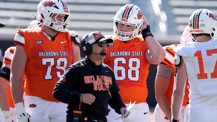 Oklahoma State coach Eric Morris, with Jacob Sexton (79) and Joseph Hanson (79). Oklahoma State coach Eric Morris, with Jacob Sexton (79) and Joseph Hanson (79).