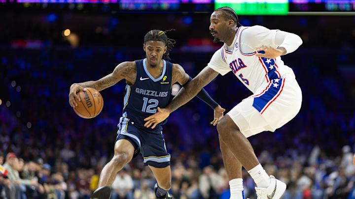 Nov 2, 2024; Philadelphia, Pennsylvania, USA; Memphis Grizzlies guard Ja Morant (12) dribbles the ball against Philadelphia 76ers center Andre Drummond (5) during the third quarter at Wells Fargo Center. Mandatory Credit: Bill Streicher-Imagn Images
