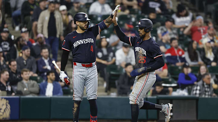 Apr 30, 2024; Chicago, Illinois, USA; Minnesota Twins outfielder Byron Buxton (25) celebrates with shortstop Carlos Correa (4) after scoring against the Chicago White Sox during the ninth inning at Guaranteed Rate Field.
