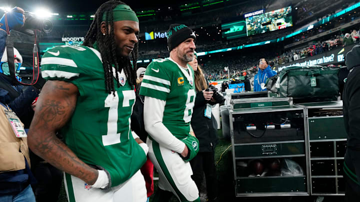 New York Jets wide receiver Davante Adams and quarterback Aaron Rodgers walk onto the field at MetLife Stadium. 