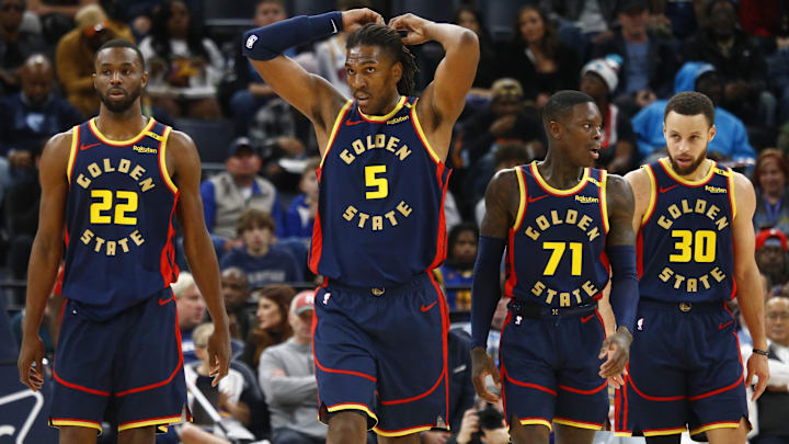 Dec 19, 2024; Memphis, Tennessee, USA; Golden State Warriors forward Andrew Wiggins (22), forward Kevon Looney (5), guard Dennis Schroder (71), and guard Stephen Curry (30) wait for play to resume during the third quarter against the Memphis Grizzlies at FedExForum. Mandatory Credit: Petre Thomas-Imagn Images