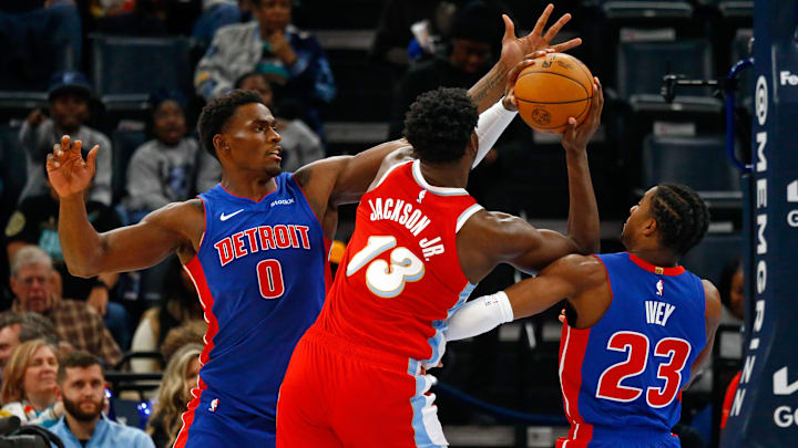 Nov 27, 2024; Memphis, Tennessee, USA; Detroit Pistons center Jalen Duren (0) and guard Jaden Ivey (23) defend as Memphis Grizzlies forward Jaren Jackson Jr. (13) : Petre Thomas-Imagn Images