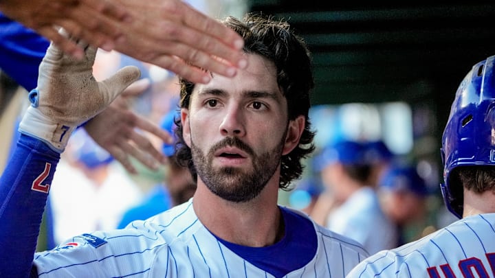 Sep 30, 2025; Chicago, Illinois, USA; Chicago Cubs infielder Dansby Swanson (7) celebrates with teammates in the dugout after scoring on a sacrifice fly in the eighth inning against the San Diego Padres during game one of the Wildcard round for the 2025 MLB playoffs at Wrigley Field. Mandatory Credit: David Banks-Imagn Images