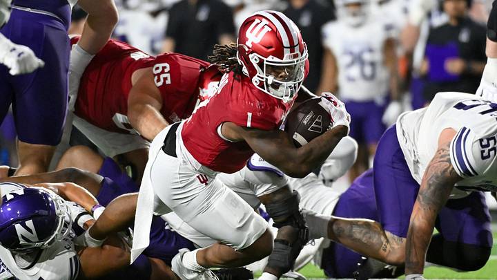 Sep 25, 2026; Bloomington, Indiana, USA; Indiana Hoosiers running back Turbo Richard (1) runs the ball against the Northwestern Wildcats during the first half at Merchants Bank Field at Memorial Stadium. Mandatory Credit: Robert Goddin-Imagn Images