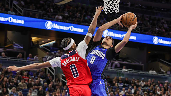 Orlando Magic guard Anthony Black (0) goes to the basket against Washington Wizards guard Bilal Coulibaly (0) during the second half at Kia Center. Orlando Magic guard Anthony Black (0) goes to the basket against Washington Wizards guard Bilal Coulibaly (0) during the second half at Kia Center.