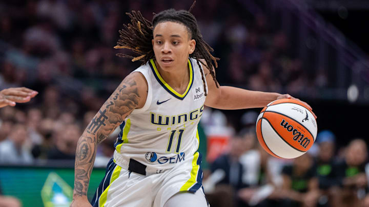 Jul 22, 2025; Seattle, Washington, USA;  Dallas Wings guard JJ Quinerly (11) dribbles the ball against the Seattle Storm at Climate Pledge Arena. Mandatory Credit: Stephen Brashear-Imagn Images