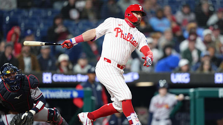 Apr 19, 2026; Philadelphia, Pennsylvania, USA; Philadelphia Phillies designated hitter Kyle Schwarber (12) hits a double against the Atlanta Braves in the fifth inning at Citizens Bank Park. 