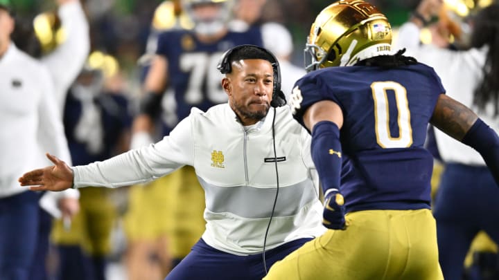 Oct 14, 2023; South Bend, Indiana, USA; Notre Dame Fighting Irish head coach Marcus Freeman celebrates with safety Xavier Watts (0) after Watts intercepted a pass in the first quarter against the USC Trojans at Notre Dame Stadium. Notre Dame won 48-20.