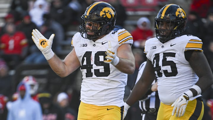 Nov 23, 2024; College Park, Maryland, USA;  Iowa Hawkeyes defensive lineman Ethan Hurkett (49) celebrates after tackling Maryland Terrapins running back Nolan Ray (not pictured) behind the line of scrimmage during the second  half at SECU Stadium. Mandatory Credit: Tommy Gilligan-Imagn Images