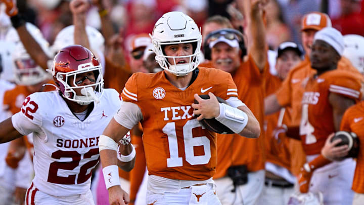 Texas Longhorns quarterback Arch Manning runs for a first down against the Oklahoma Sooners during the second half at the Cotton Bowl.