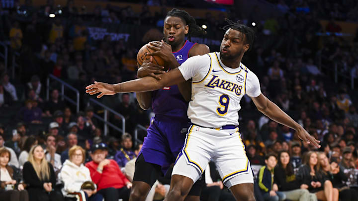 Nov 10, 2024; Los Angeles, California, USA; Los Angeles Lakers guard Bronny James (9) guards Toronto Raptors forward Jonathan Mogbo (2) during the second half at Crypto.com Arena. Mandatory Credit: Jonathan Hui-Imagn Images Nov 10, 2024; Los Angeles, California, USA; Los Angeles Lakers guard Bronny James (9) guards Toronto Raptors forward Jonathan Mogbo (2) during the second half at Crypto.com Arena. Mandatory Credit: Jonathan Hui-Imagn Images