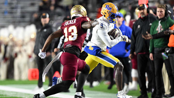 Nov 30, 2024; Chestnut Hill, Massachusetts, USA; Pittsburgh Panthers wide receiver Konata Mumpfield (9) runs against Boston College Eagles defensive back Max Tucker (13) during the first half at Alumni Stadium. Mandatory Credit: Brian Fluharty-Imagn Images Nov 30, 2024; Chestnut Hill, Massachusetts, USA; Pittsburgh Panthers wide receiver Konata Mumpfield (9) runs against Boston College Eagles defensive back Max Tucker (13) during the first half at Alumni Stadium. Mandatory Credit: Brian Fluharty-Imagn Images