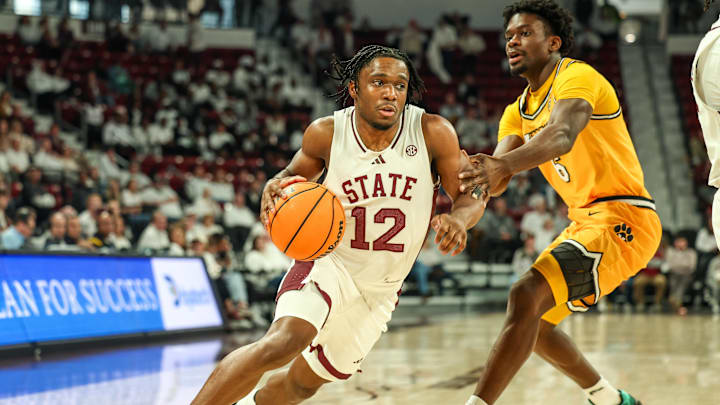 Feb 1, 2025; Starkville, Mississippi, USA; Mississippi State Bulldogs guard Josh Hubbard (12) drives to the basket against Missouri Tigers guard Annor Boateng (6) during the second half at Humphrey Coliseum. Mandatory Credit: Wesley Hale-Imagn Images