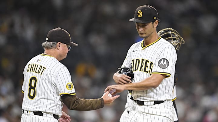Sep 2, 2025; San Diego, California, USA; San Diego Padres starting pitcher Yu Darvish (11) hands the ball to manager Mike Shildt (8) as he leaves the game during the fifth inning against the Baltimore Orioles at Petco Park. Mandatory Credit: Denis Poroy-Imagn Images