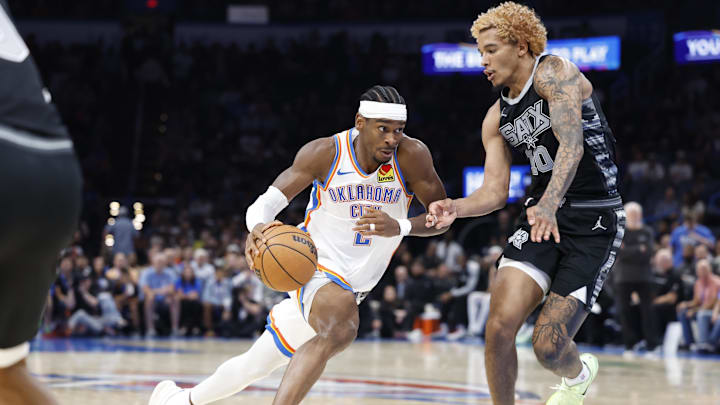 Oct 30, 2024; Oklahoma City, Oklahoma, USA; Oklahoma City Thunder guard Shai Gilgeous-Alexander (2) drives to the basket against San Antonio Spurs forward Jeremy Sochan (10) during the second half at Paycom Center. Mandatory Credit: Alonzo Adams-Imagn Images Oct 30, 2024; Oklahoma City, Oklahoma, USA; Oklahoma City Thunder guard Shai Gilgeous-Alexander (2) drives to the basket against San Antonio Spurs forward Jeremy Sochan (10) during the second half at Paycom Center. Mandatory Credit: Alonzo Adams-Imagn Images