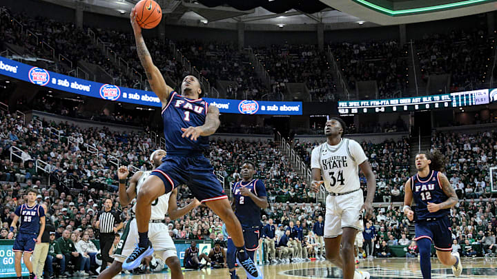 Dec 21, 2024; East Lansing, Michigan, USA;  Florida Atlantic Owls forward Kaleb Glenn (1) scores on a steal during the first half against the Michigan State Spartans at Jack Breslin Student Events Center. Mandatory Credit: Dale Young-Imagn Images