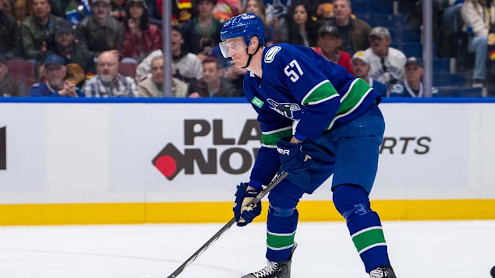 Apr 16, 2024; Vancouver, British Columbia, CAN; Vancouver Canucks defenseman Tyler Myers (57) handles the puck against the Calgary Flames in the first period at Rogers Arena. Mandatory Credit: Bob Frid-Imagn Images