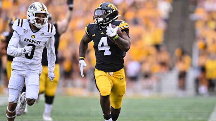Sep 16, 2023; Iowa City, Iowa, USA; Iowa Hawkeyes running back Leshon Williams (4) runs the ball as Western Michigan Broncos cornerback DaShon Bussell (0) moves in for the tackle during the second quarter at Kinnick Stadium. Mandatory Credit: Jeffrey Becker-USA TODAY Sports