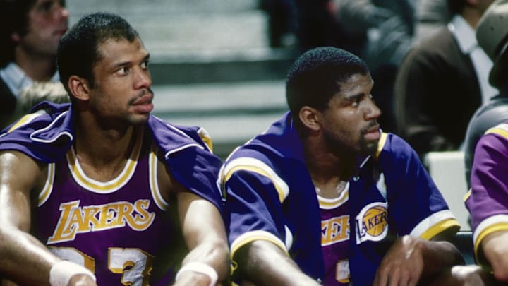 Los Angeles Lakers center Kareem Abdul-Jabbar (33) and Magic Johnson (32) on the bench against the Portland Trail Blazers at Memorial Coliseum.
