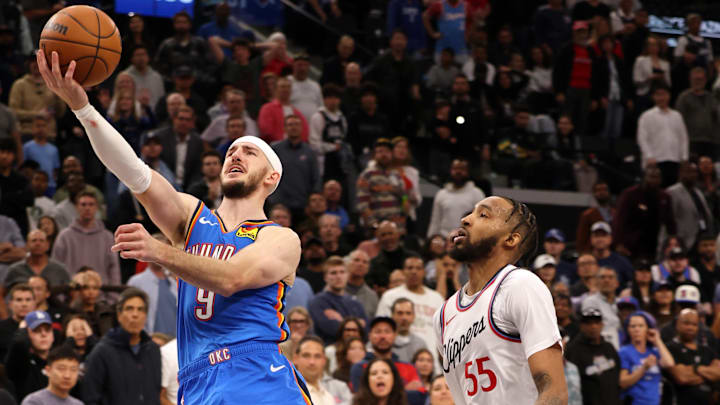 Mar 23, 2025; Inglewood, California, USA; Oklahoma City Thunder guard Alex Caruso (9) shoots against LA Clippers forward Derrick Jones Jr. (55) during the 4th quarter at Intuit Dome. Mandatory Credit: Jason Parkhurst-Imagn Images
